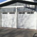 two white garage doors with windows