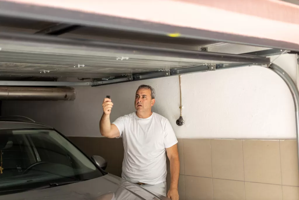 man watching as garage door jerks when opening