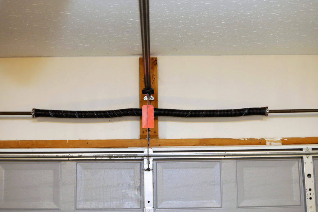 what causes a garage door spring to break